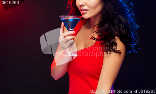 Image of close up of sexy drinking cocktail at nightclub