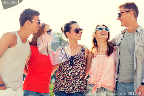 Image of group of smiling friends in city