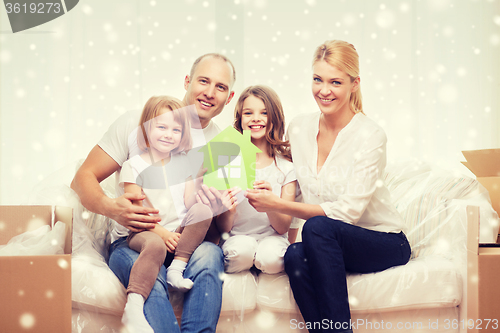 Image of smiling parents and two little girls at new home