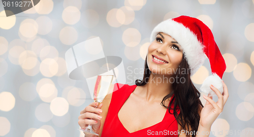 Image of beautiful woman in santa hat with champagne glass