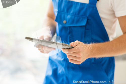 Image of close up of builder or workman with tablet pc