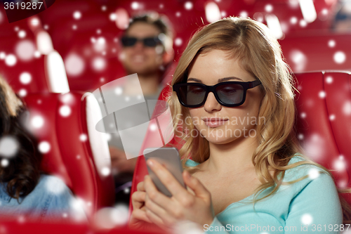 Image of happy woman with smartphone in 3d movie theater