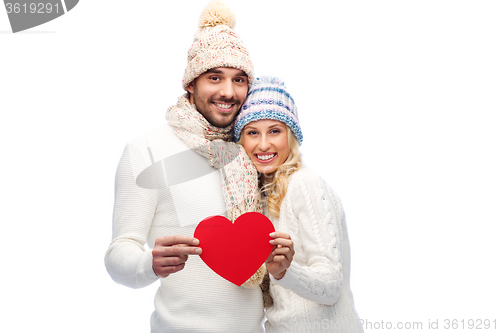 Image of smiling couple in winter clothes with red hearts