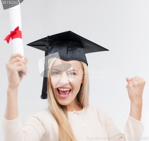 Image of student in graduation cap with certificate