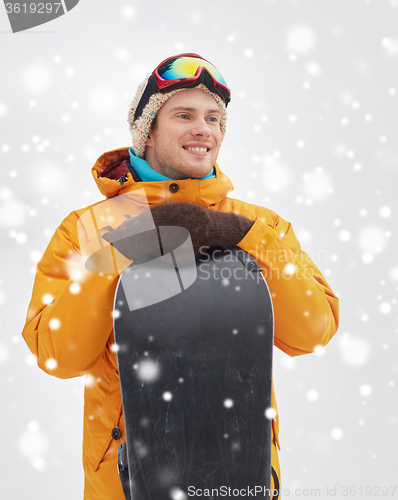 Image of happy young man in ski goggles outdoors