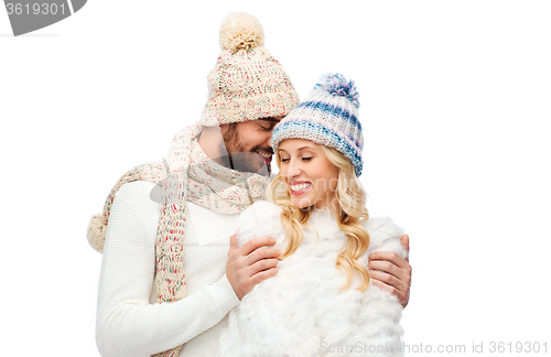 Image of smiling couple in winter clothes hugging