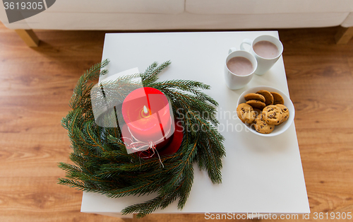 Image of close up of christmas wreath with candle on table