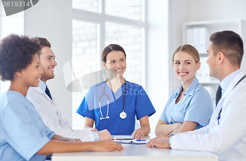 Image of group of happy doctors meeting at hospital office