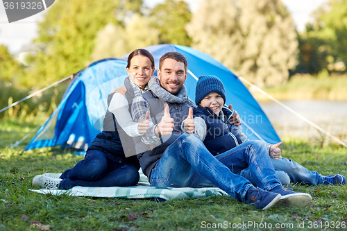 Image of happy family with tent at camp site