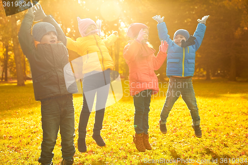Image of group of happy children having fun in autumn park