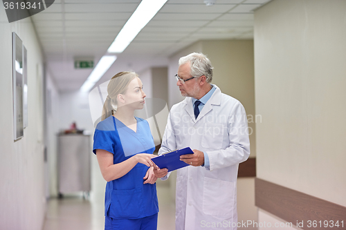 Image of senior doctor and nurse with tablet pc at hospital