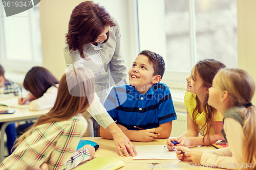 Image of group of school kids writing test in classroom