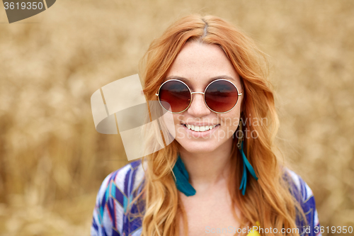 Image of smiling young redhead hippie woman outdoors