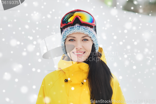 Image of happy young woman in ski goggles outdoors