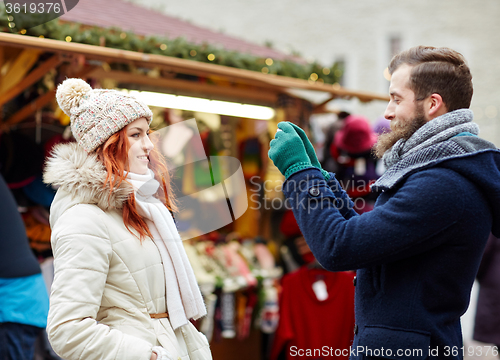 Image of couple taking selfie with smartphone in old town