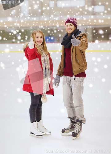 Image of happy couple holding hands on skating rink