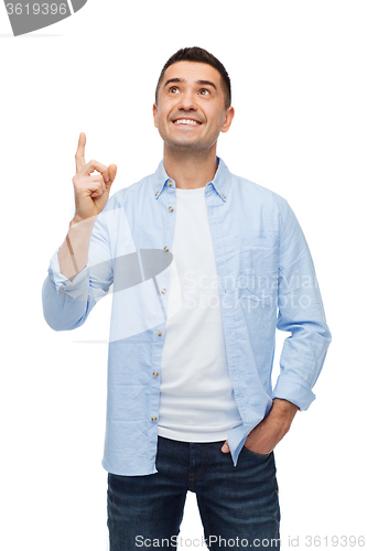 Image of smiling man pointing finger up