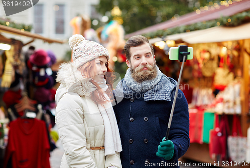 Image of couple taking selfie with smartphone in old town