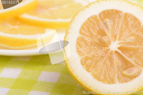 Image of Background of yellow ripe lemons. A slice of lemon.