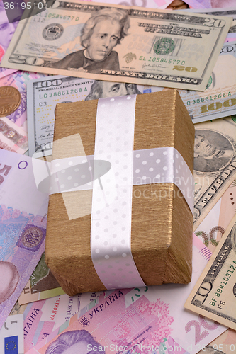 Image of american money and golden gift box, european money