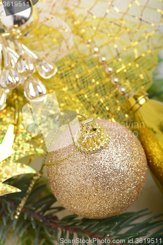 Image of luxury gift boxes under Christmas tree, New Year home decorations, golden wrapping of Santa presents, festive fir tree decorated with garland, baubles set, traditional celebration