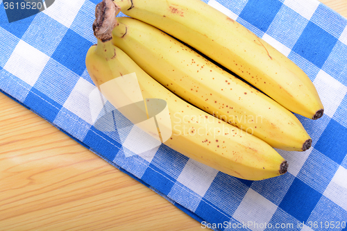 Image of Bunch of bananas on white bowl, health food concept