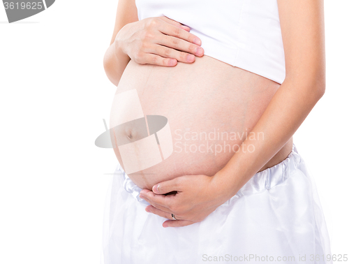 Image of Pregnant woman touching her belly