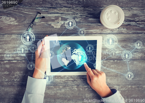 Image of close up of hands with tablet pc and network