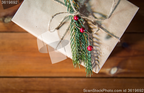 Image of close up of christmas gift box with fir brunch