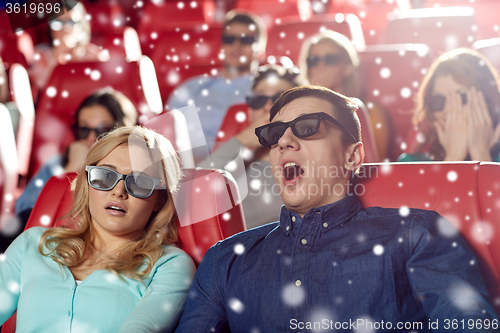 Image of scared friends watching horror movie in 3d theater