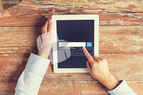 Image of close up of male hands using browser on tablet pc