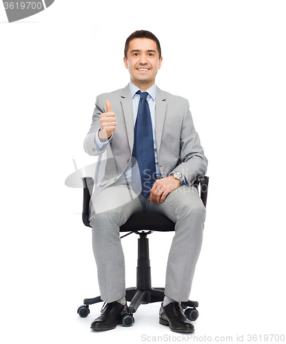 Image of happy businessman  sitting in office chair