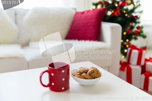 Image of close up of christmas cookies and red cup on table