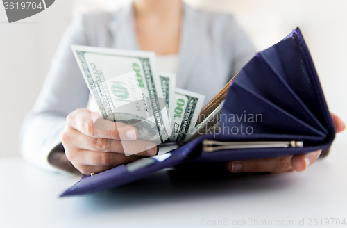 Image of close up of woman hands with wallet and money