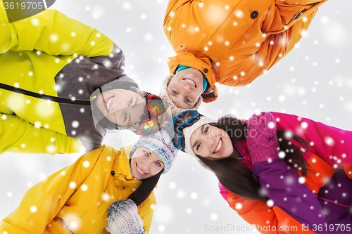 Image of happy friends in ski goggles outdoors