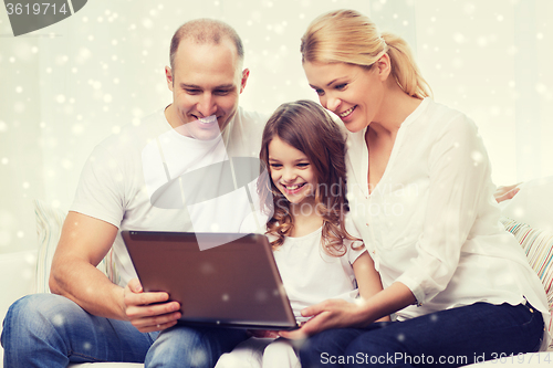 Image of smiling family with laptop at home