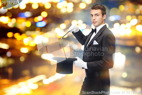 Image of magician in top hat with magic wand showing trick