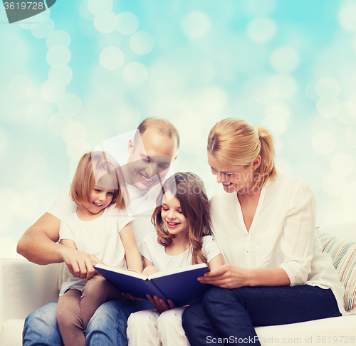 Image of happy family with book at home