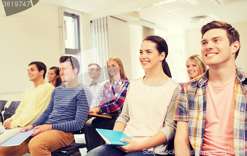 Image of group of smiling students in lecture hall