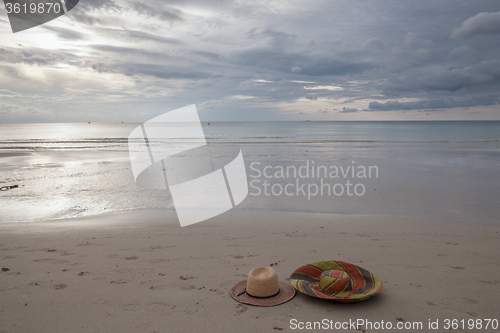 Image of Beach on tropical island. Clear blue water, sand, clouds. 