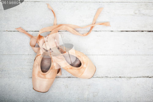 Image of Pointe shoes on wooden background
