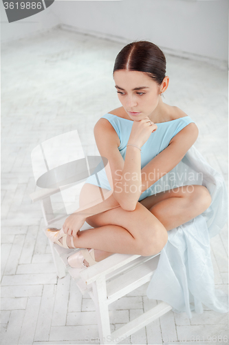 Image of young modern ballet dancer posing on white background