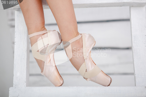 Image of the legs of a ballerina on white background