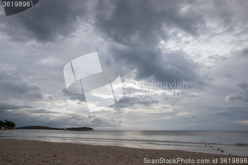 Image of Beach on tropical island. Clear blue water, sand, clouds. 