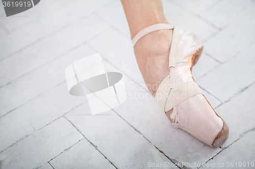 Image of the leg of a ballerina on white background