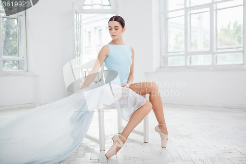 Image of young modern ballet dancer posing on white background