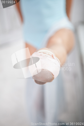 Image of the leg of a ballerina on white background