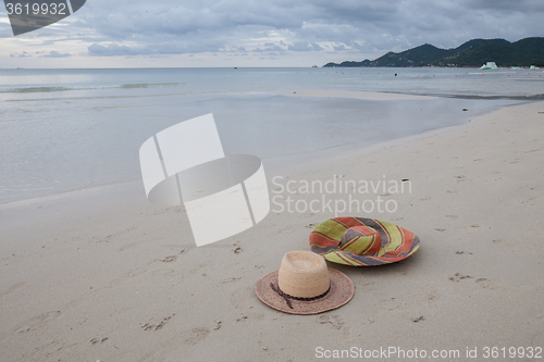 Image of Beach on tropical island. Clear blue water, sand, clouds. 