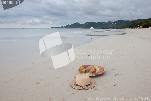 Image of Beach on tropical island. Clear blue water, sand, clouds. 