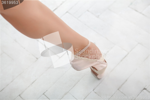 Image of the leg of a ballerina on white background